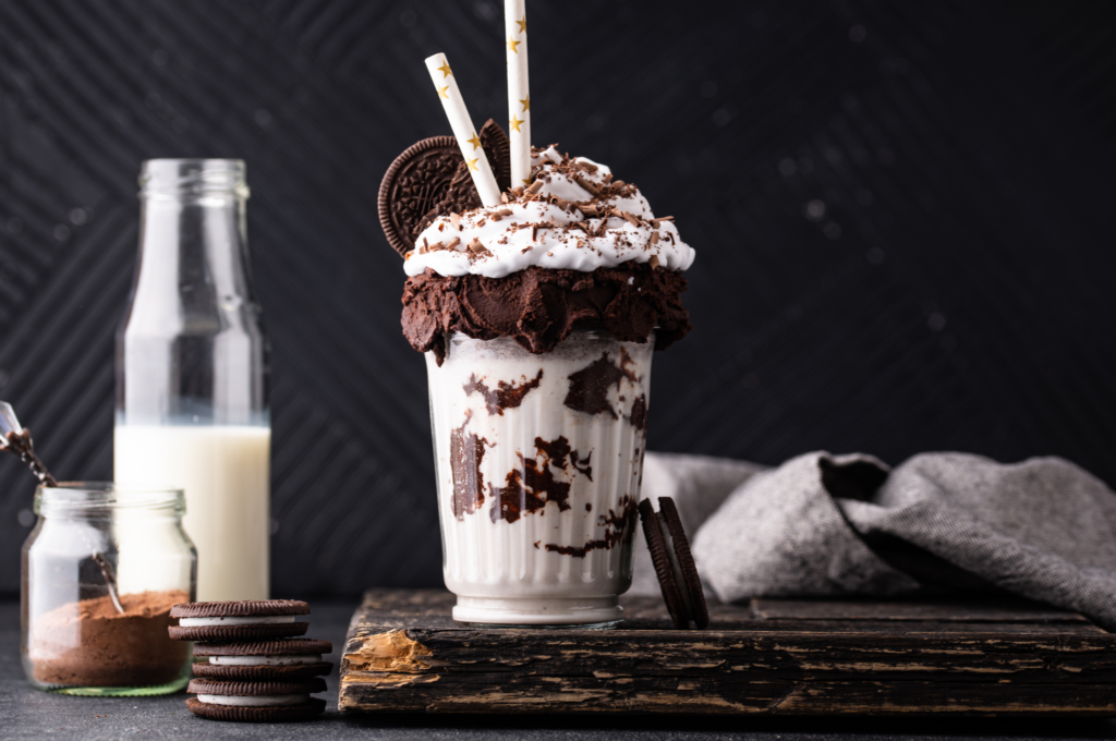 Chocolate milkshake with unhealthy foods, binge eating